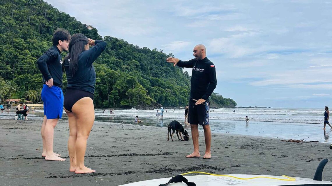 Semi-private surf lessons in Jaco with Ride In instructors and students on the beach